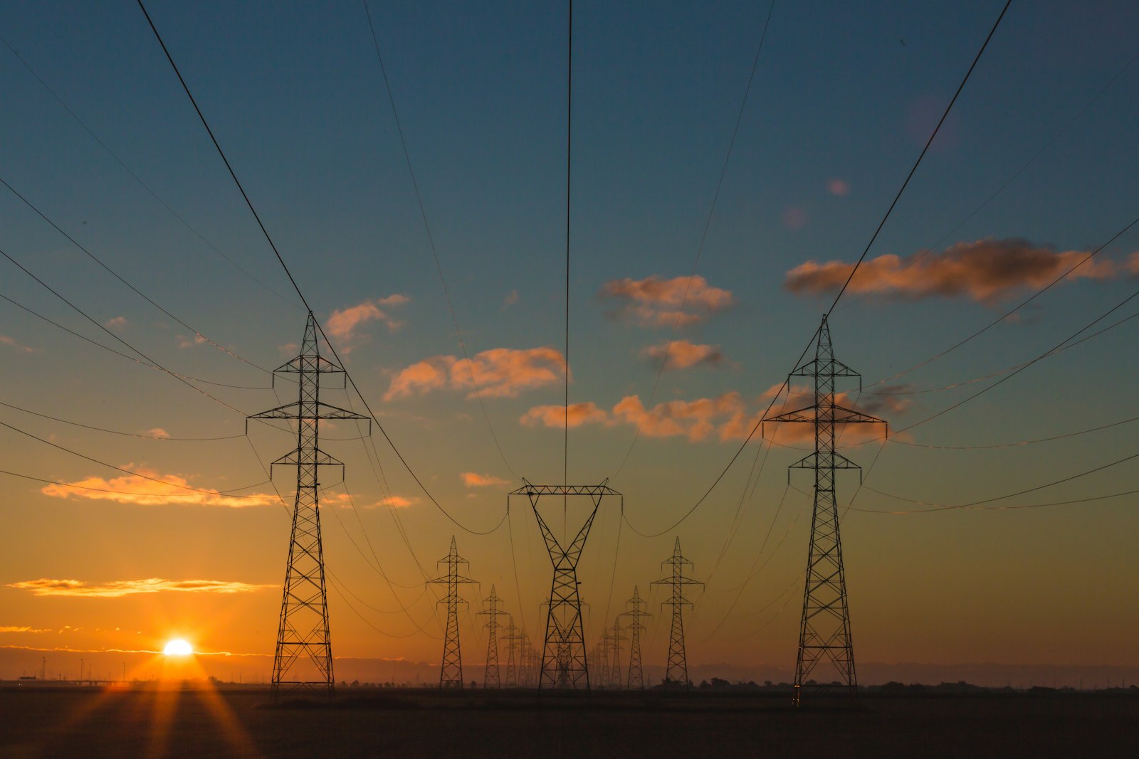 High-voltage power lines at sunset
