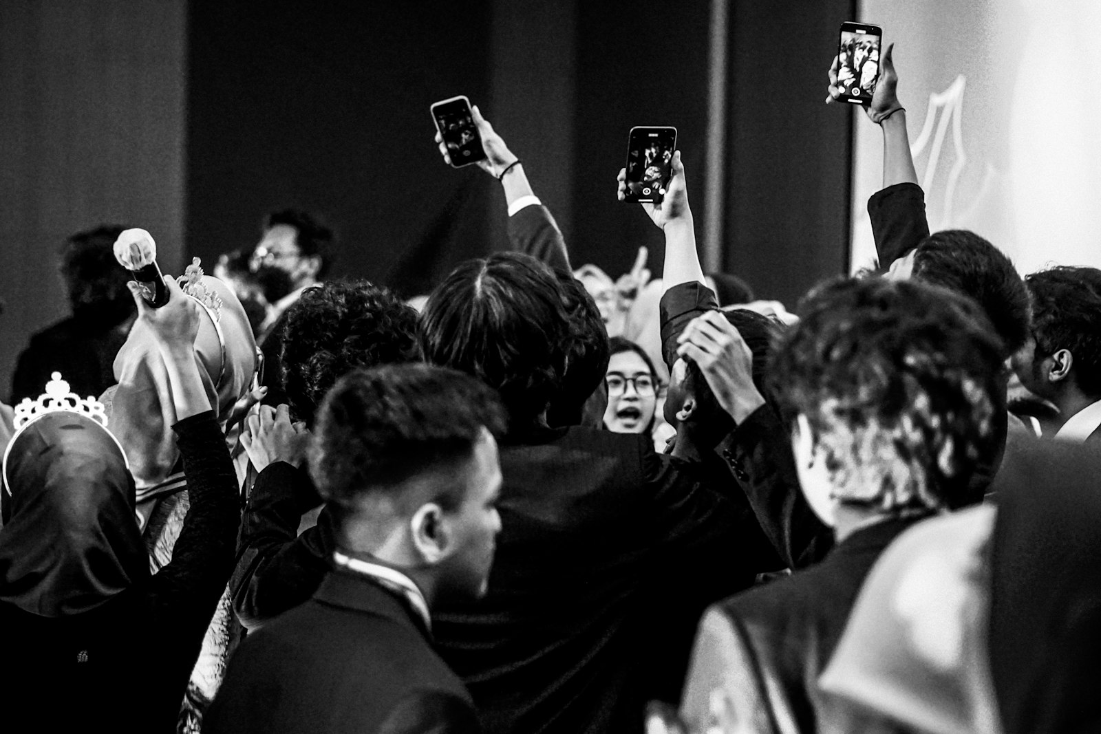 People filming an event with smartphones